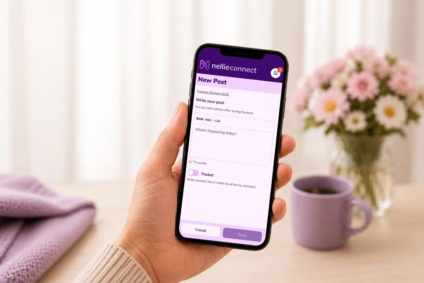 A hand writing a new post in the nellie connect app